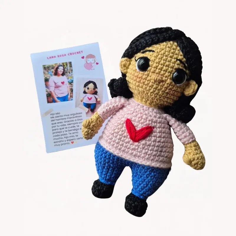 Amigurumi con blusa rosada y corazón rojo junto a su tarjeta de regalo personalizada